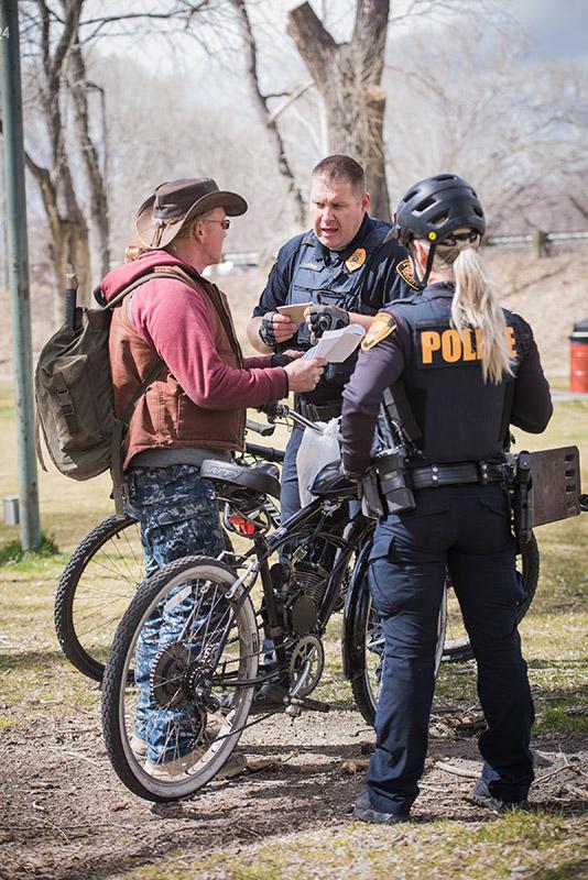 Prescott Police Bike Patrol talking with man in park