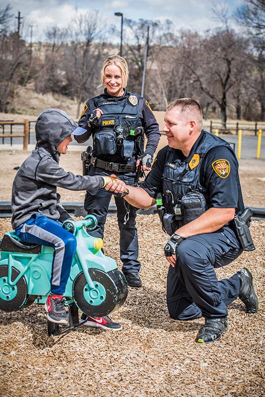 Prescott Police Officers interacting with child at park