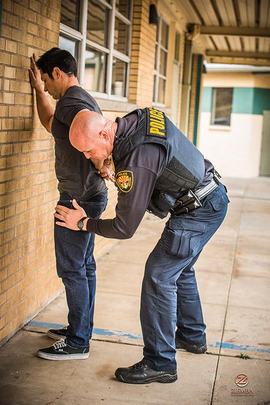 Prescott Police Officer patting down a suspect